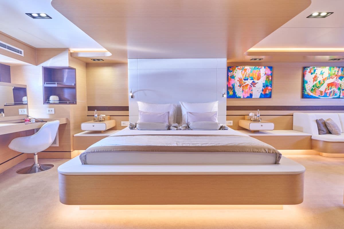 Modern bedroom cabin with wood paneling, floating bed, and colorful abstract art