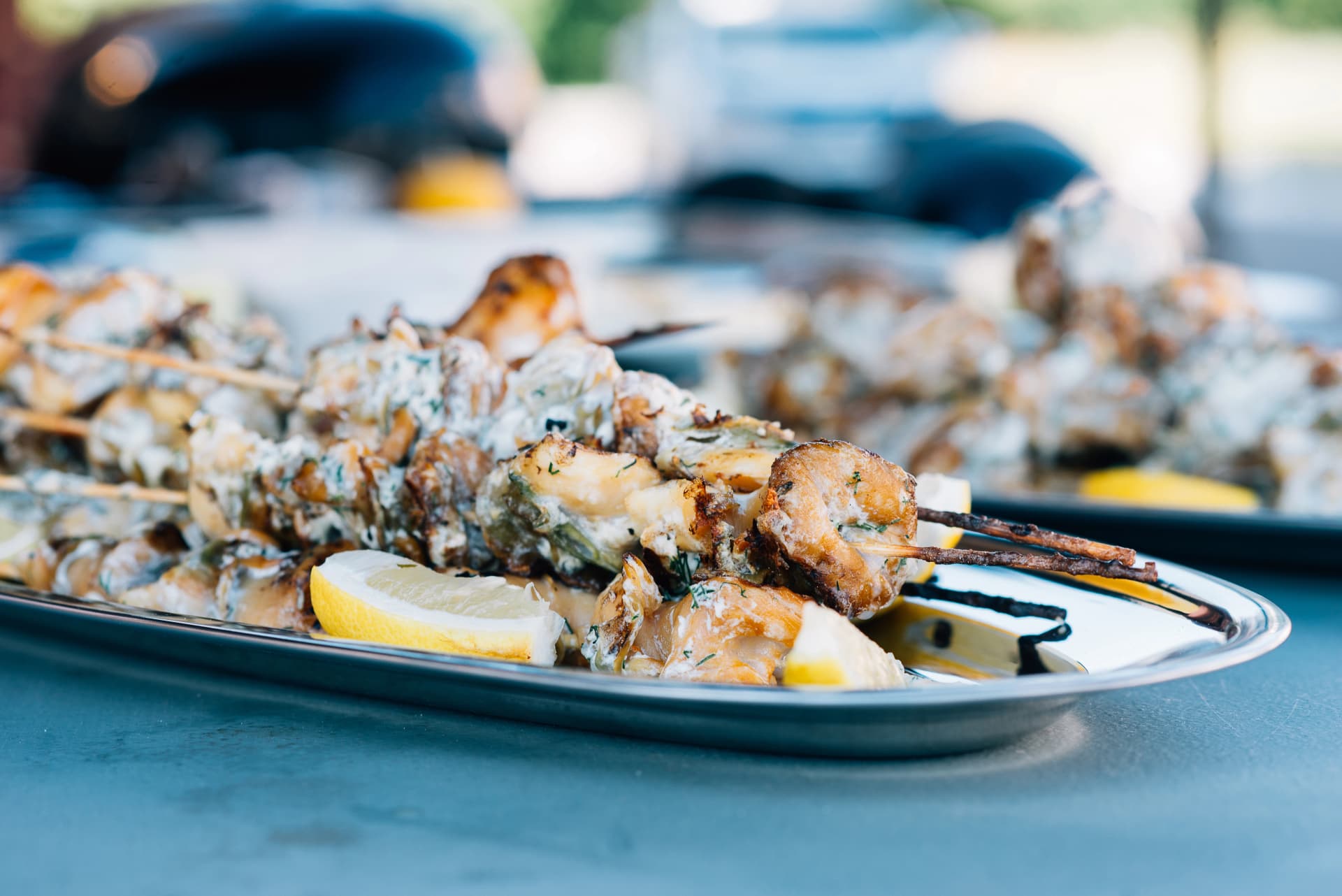 Grilled shellfish with lemon served on silver plate