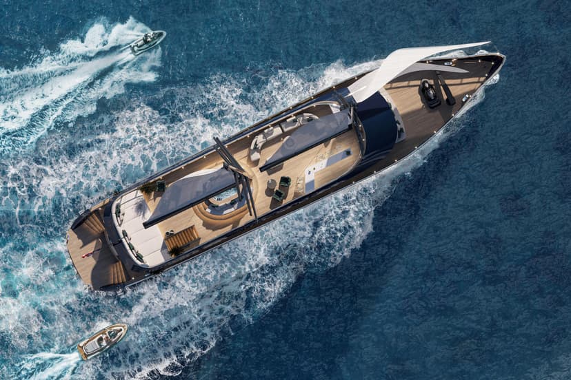 Aerial view of a luxury yacht sailing on blue ocean water with smaller watercraft nearby