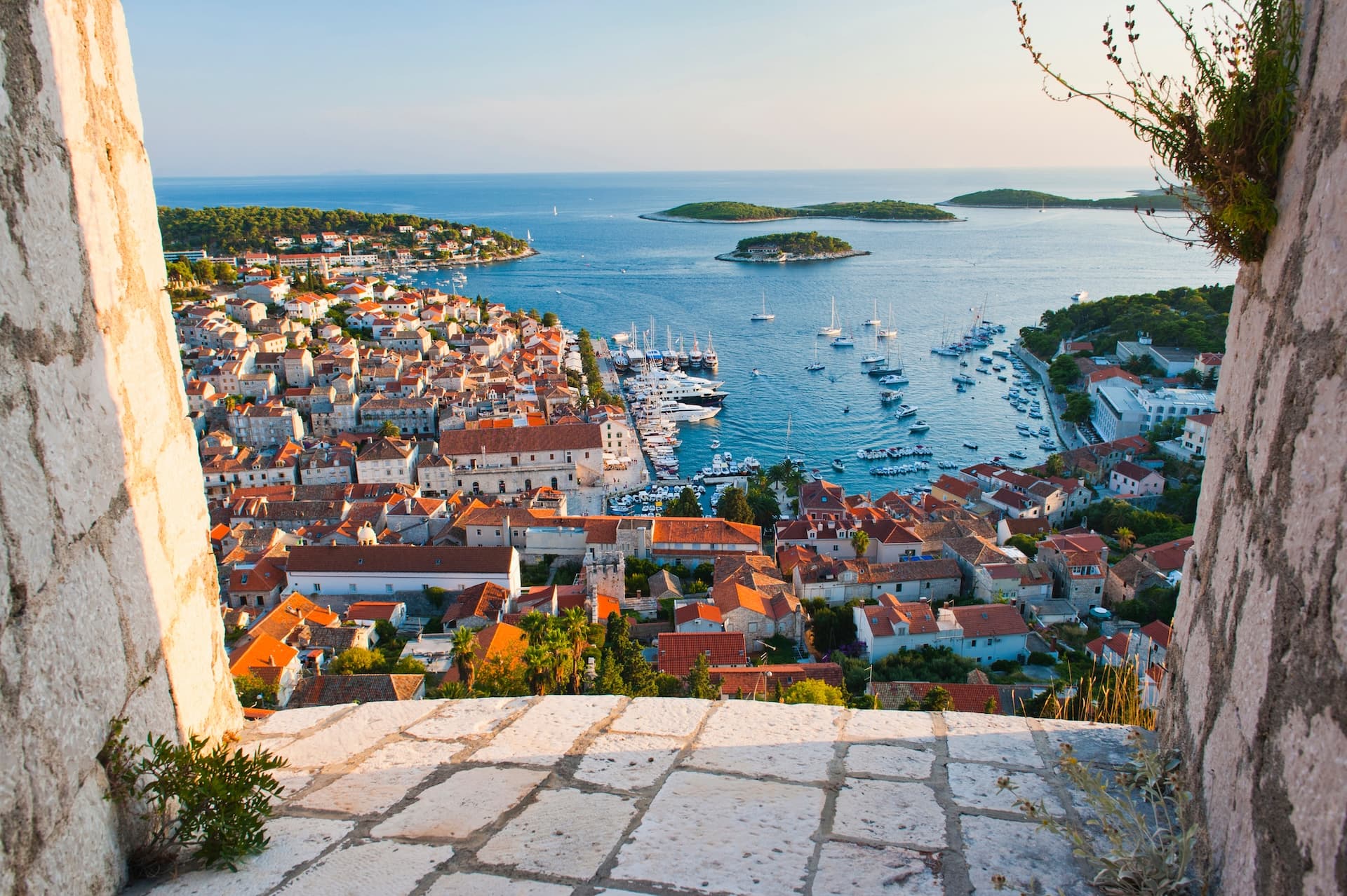 View over Hvar Island town, harbor, and Adriatic Sea from stone fortification.