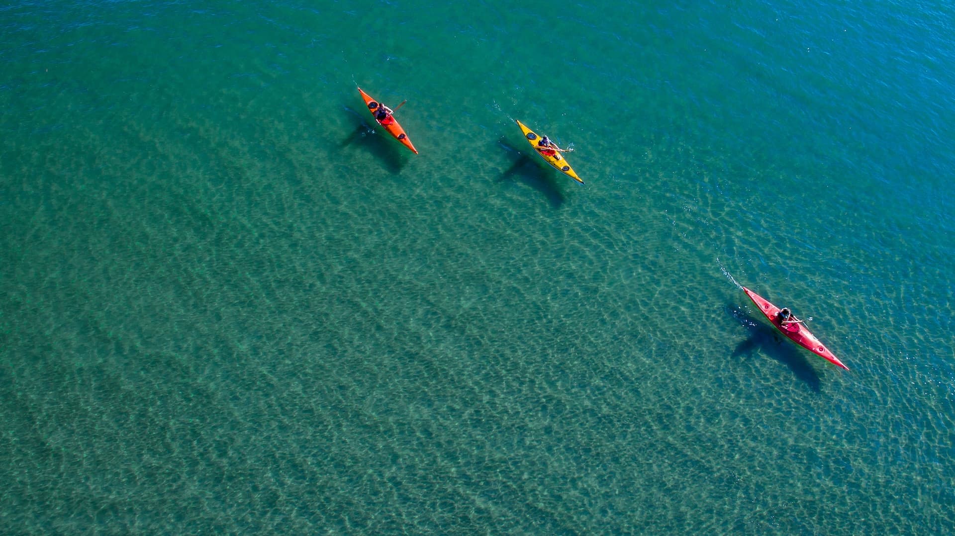 Kayaking on clear turquoise sea water near Korčula, Croatia.